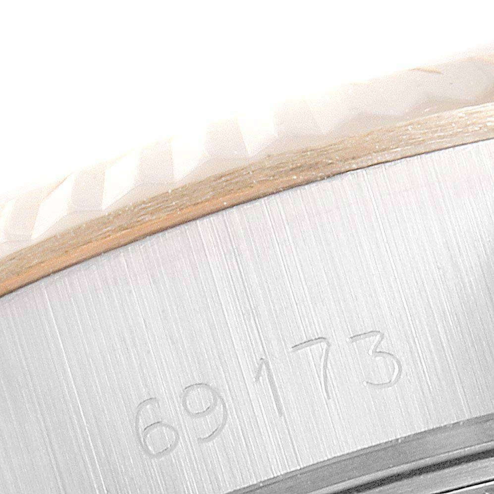 This close-up shows the side of a Rolex Datejust 69173 Women's Stainless Steel Beige Dial 69173 Women's Stainless Steel Beige Dial 69173 with visible engravings.