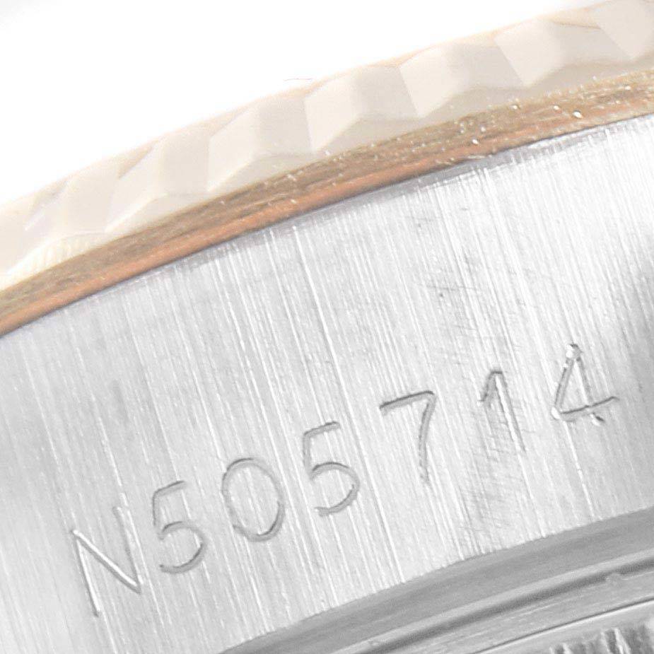 This close-up image shows the serial number engraving on the case of a Rolex Datejust 69173 Women's Stainless Steel Beige Dial 69173 Women's Stainless Steel Beige Dial watch.