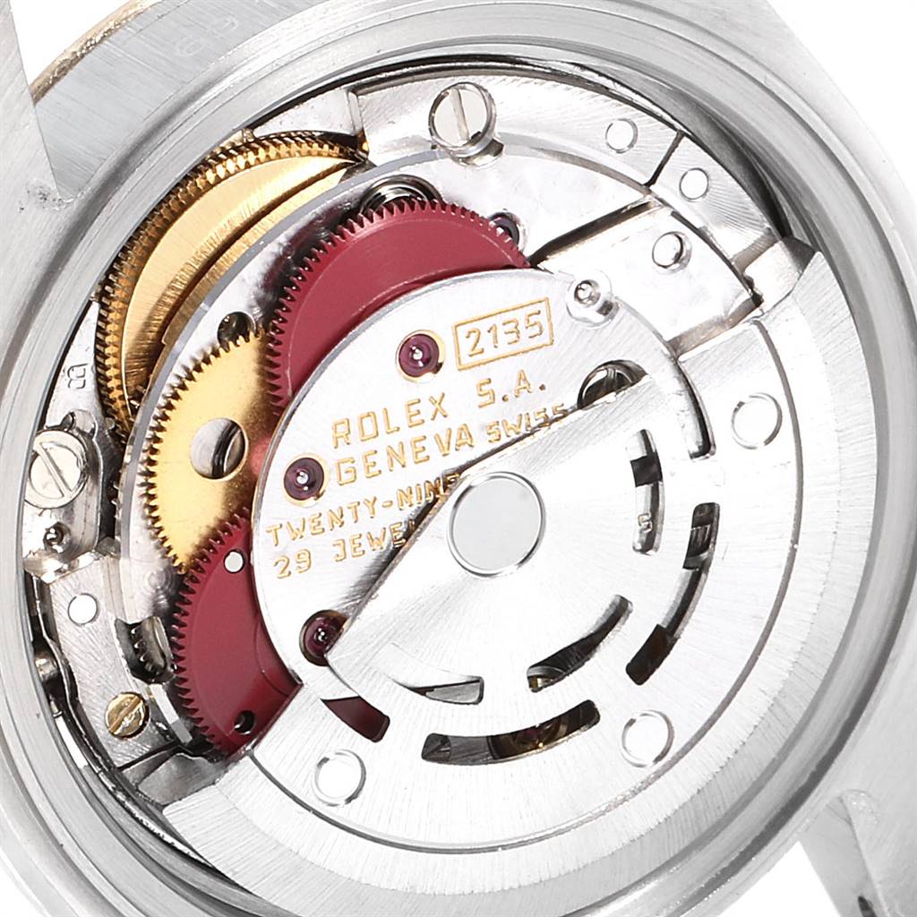 This image shows a close-up of the movement mechanism inside a Rolex Datejust 69173 Women's Stainless Steel Red Dial 69173 Women's Stainless Steel Red Dial watch, exposing the intricate gears and components.