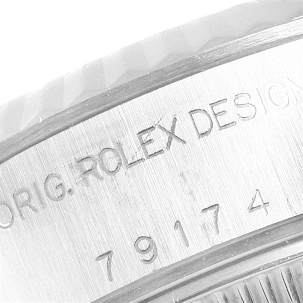 The image shows a close-up of the side engraving on a Rolex Datejust 79174 Women
s Stainless Steel Silver Dial 79174 Women
s Stainless Steel Silver Dial watch, featuring the model number and design details.