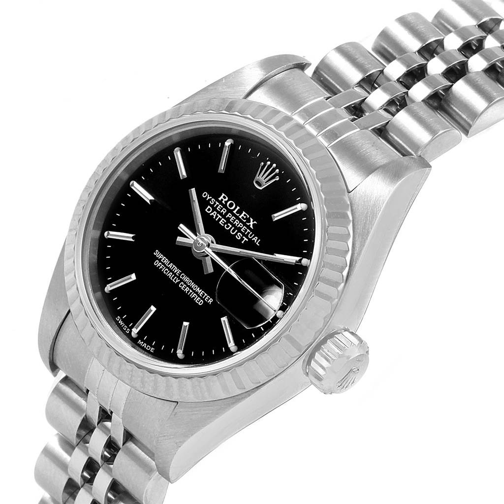 The image shows a close-up angled view of a Rolex Datejust 79174 Women
s Stainless Steel Black Dial 79174 Women
s Stainless Steel Black Dial watch, highlighting the black dial, fluted bezel, crown, and bracelet.