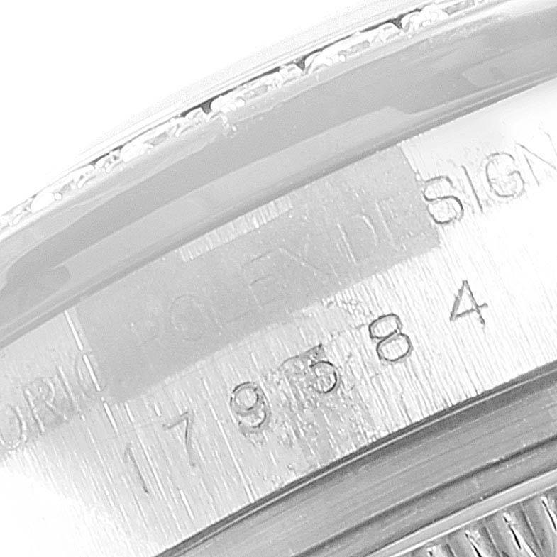 This image shows a close-up of the case back of the Rolex Datejust 179384 Women
s Stainless Steel Black Dial 179384 Women
s Stainless Steel Black Dial, highlighting the engraved serial number and "Rolex Design."