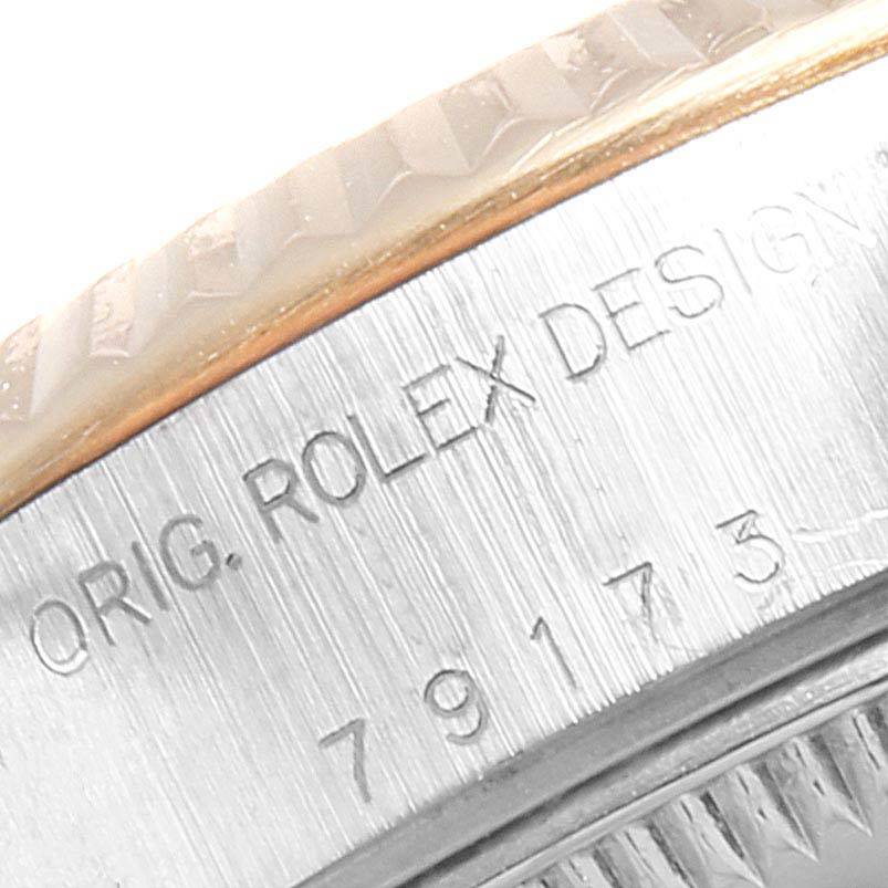 This image shows a close-up of the engraved details on the side of a Rolex Datejust 79173 Women
s Stainless Steel Blue Dial 79173 Women
s Stainless Steel Blue Dial watch bezel.