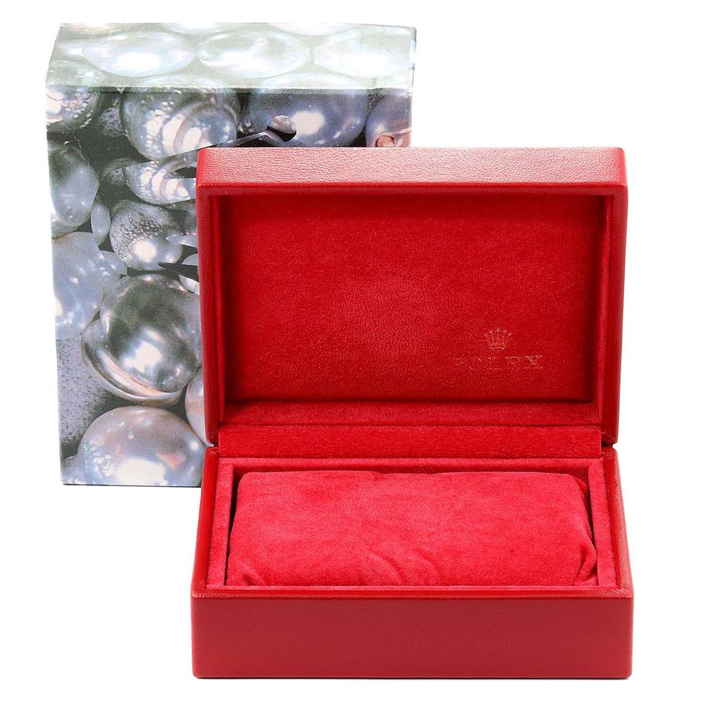 This image shows an empty red Rolex Datejust 79173 Women
s Stainless Steel Blue Dial 79173 Women
s Stainless Steel Blue Dial watch box, with the interior exposed and lid open, set against a decorative outer box.