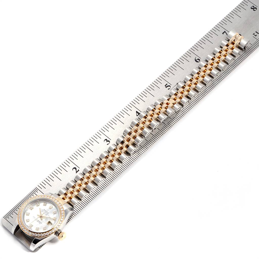 This image shows the face and part of the bracelet of the Rolex Datejust 179383 Women
s Steel and Gold (two tone) Mother of Pearl Dial 179383 Women
s Steel and Gold (two tone) Mother of Pearl Dial model, with a ruler measuring it.