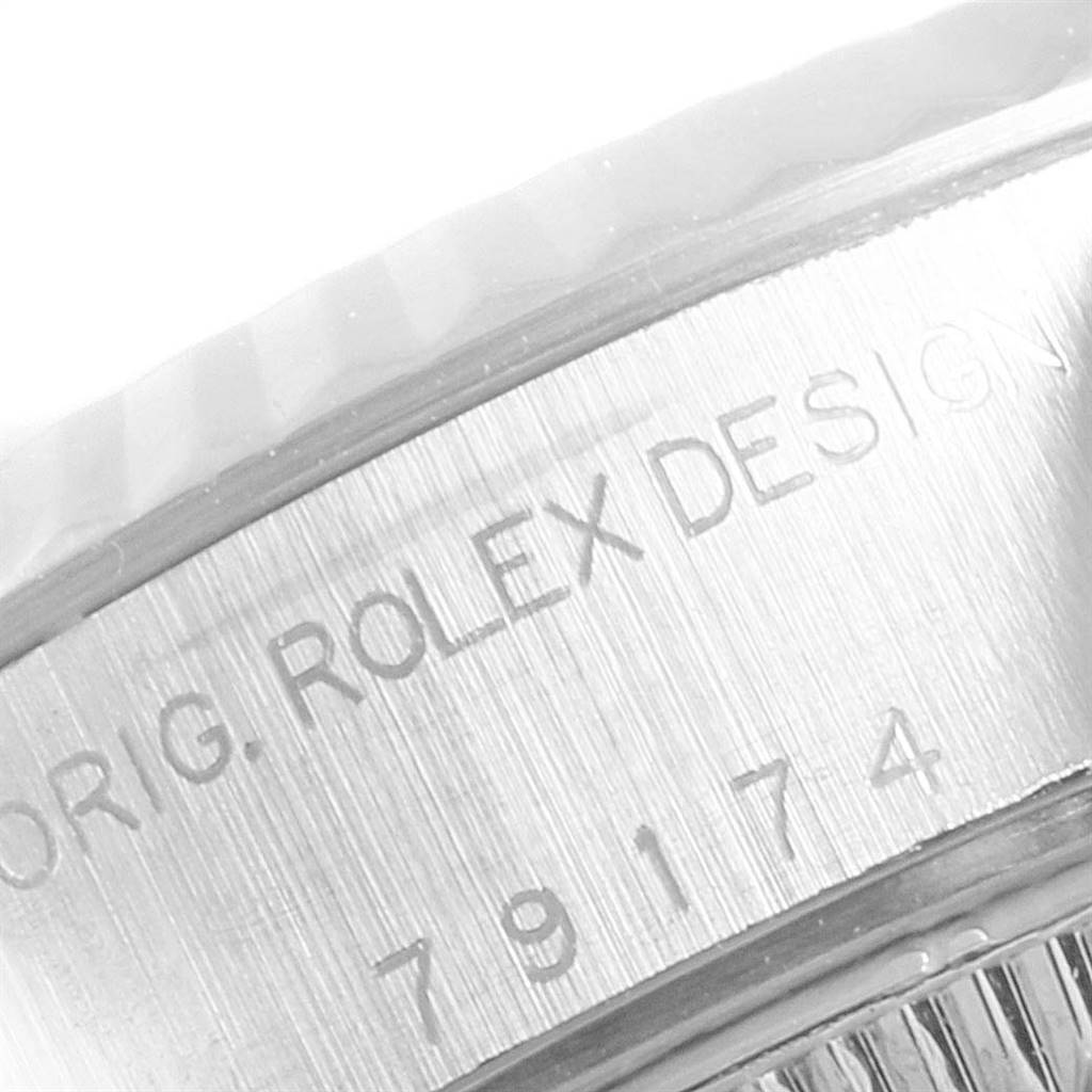 The image shows a close-up of the side of a Rolex Datejust 79174 Women
s Stainless Steel Black Dial 79174 Women
s Stainless Steel Black Dial watch, focusing on the engraved model number and markings.