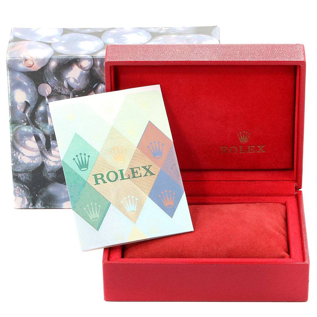 The image shows a Rolex Datejust 79174 Women
s Stainless Steel Black Dial 79174 Women
s Stainless Steel Black Dial packaging with a red box, the cushion, and a colorful booklet.