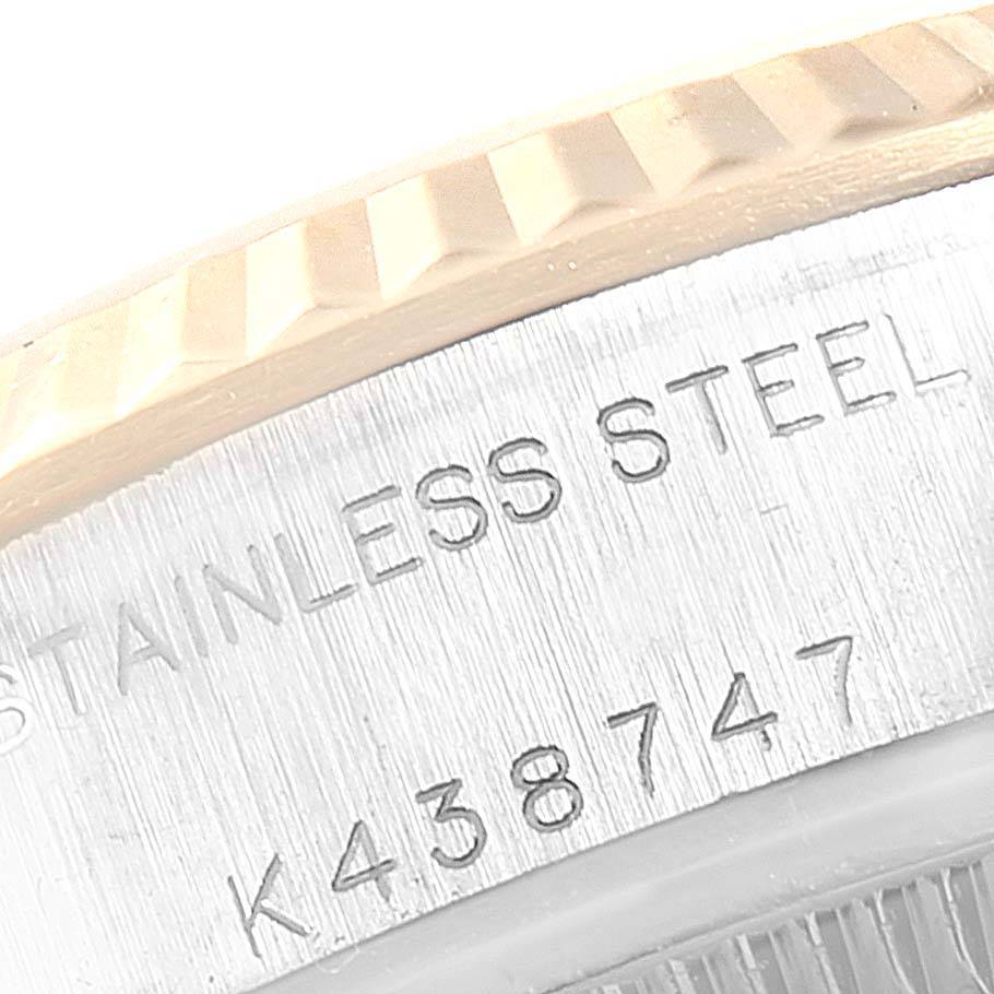 This image shows a close-up of the Rolex Datejust 79173 Women's Steel and Gold (two tone) Champagne Dial 79173 Women's Steel and Gold (two tone) Champagne Dial's fluted bezel and stainless steel case with part of the serial number visible.