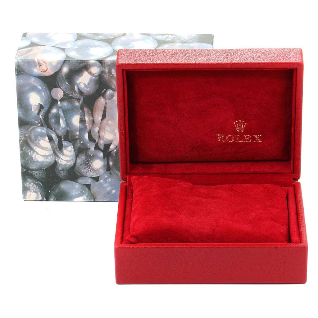This image shows a Rolex Datejust 79173 Women's Steel and Gold (two tone) Champagne Dial 79173 Women's Steel and Gold (two tone) Champagne Dial watch box and packaging from a front angle, featuring a red interior and a multicolored outer box.
