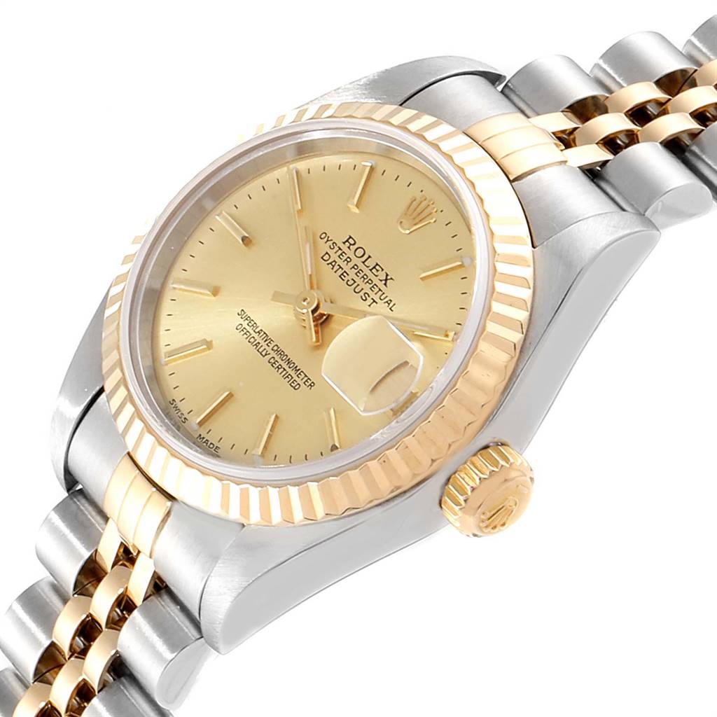The image shows a close-up of a Rolex Datejust 79173 Women's Steel and Gold (two tone) Champagne Dial 79173 Women's Steel and Gold (two tone) Champagne Dial watch, highlighting its face, bezel, crown, and part of its bracelet from a side angle.