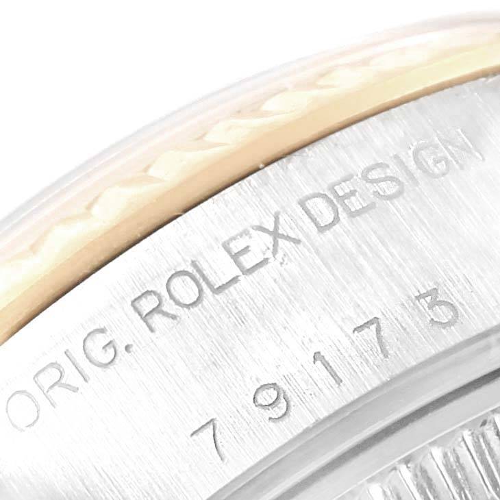 The image shows a close-up angle of the case side of a Rolex Datejust 79173 Women's Steel and Gold (two tone) Champagne Dial 79173 Women's Steel and Gold (two tone) Champagne Dial, highlighting the engraved serial and "ORIG. ROLEX DESIGN".