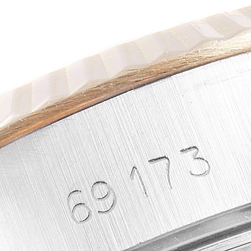 This image shows a close-up of the case side, bezel, and part of the serial number of a Rolex Datejust 69173 Women's Stainless Steel Champagne Dial 69173 Women's Stainless Steel Champagne Dial model.