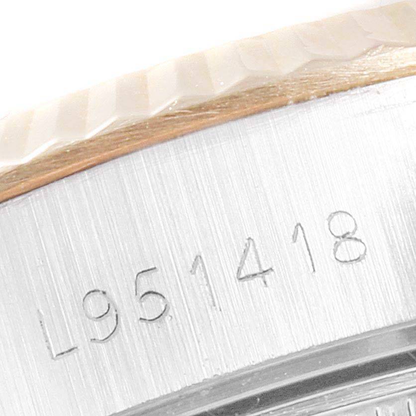 This is a close-up of the serial number on the casing of a Rolex Datejust 69173 Women's Stainless Steel Champagne Dial 69173 Women's Stainless Steel Champagne Dial watch, showing part of the bezel.