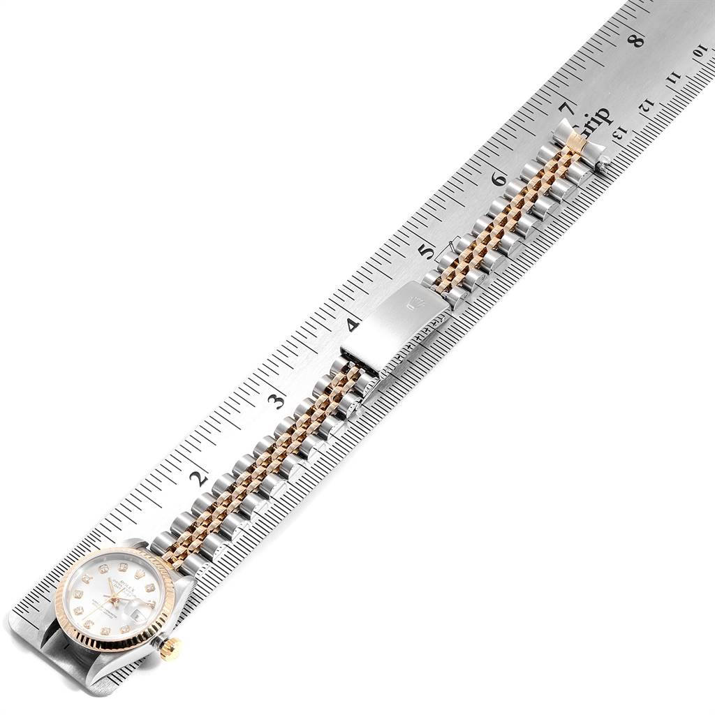 The Rolex Datejust 69173 Women's Stainless Steel Silver Dial 69173 Women's Stainless Steel Silver Dial watch is shown from a top-down angle, displaying the dial, bezel, bracelet, and clasp on a ruler.