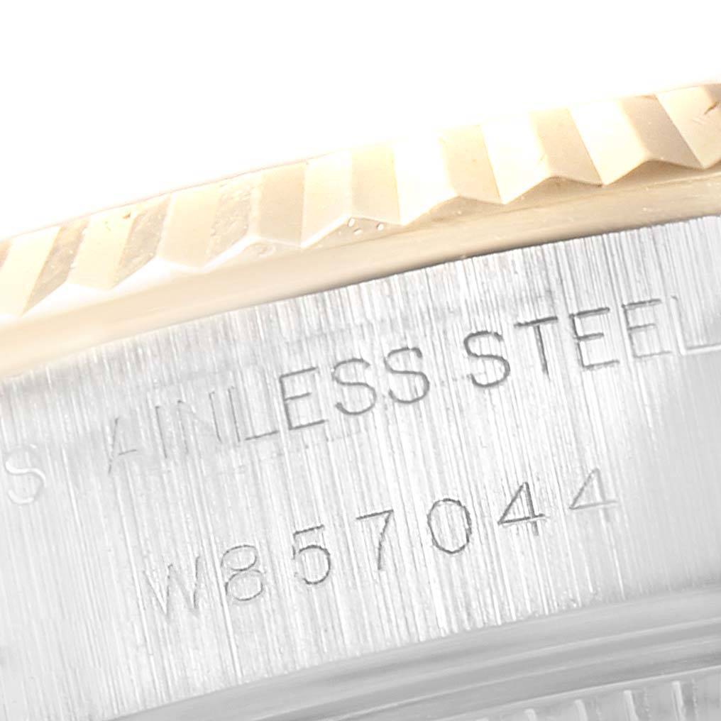 A close-up of the Rolex Datejust 69173 Women's Stainless Steel Champagne Dial 69173 Women's Stainless Steel Champagne Dial watch showing the fluted bezel and stainless steel casing with an engraved serial number.