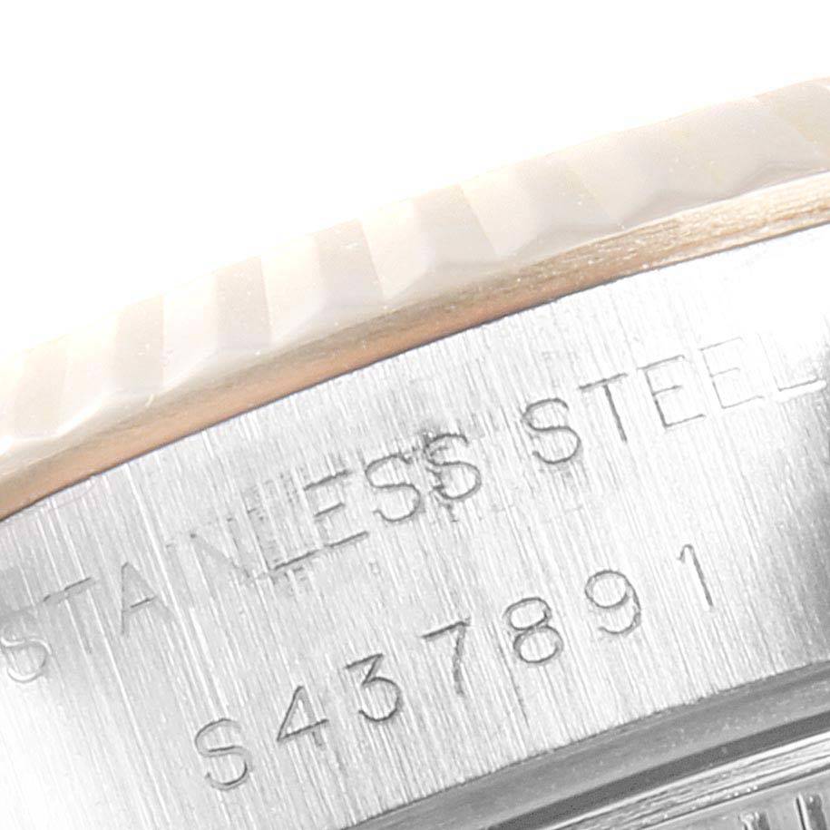 Close-up angle showing the side of the bezel and part of the case with the serial number on a Rolex Datejust 69173 Women's Steel and Gold (two tone) Champagne Dial 69173 Women's Steel and Gold (two tone) Champagne Dial.