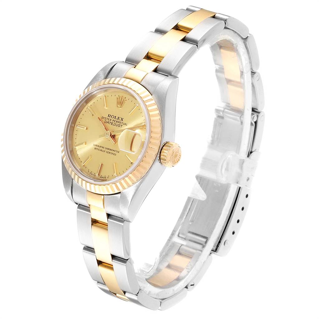 The Rolex Datejust 69173 Women's Steel and Gold (two tone) Champagne Dial 69173 Women's Steel and Gold (two tone) Champagne Dial watch is shown at a slightly tilted angle, highlighting its gold dial, fluted bezel, and two-tone bracelet.