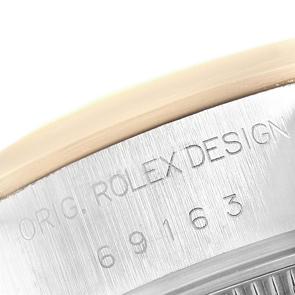 The image shows a close-up of the serial number and "ROLEX DESIGN" engraving on the side of a Rolex Datejust 79163 Women's Steel and Gold (two tone) Champagne Dial 79163 Women's Steel and Gold (two tone) Champagne Dial watch case.