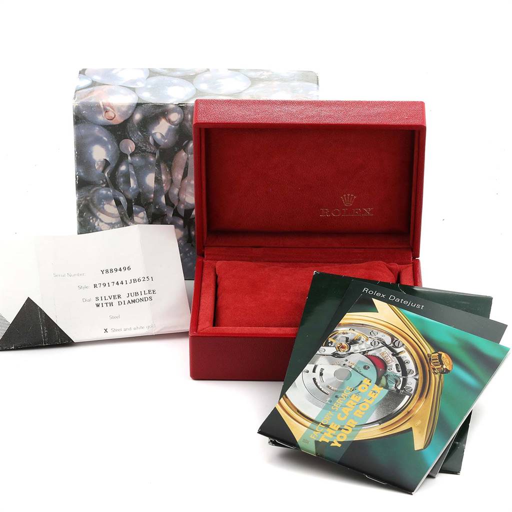 The image shows the packaging and documents of a Rolex Datejust 79174 Women
s Stainless Steel Silver Dial 79174 Women
s Stainless Steel Silver Dial watch, including a red box, manuals, and an information card.