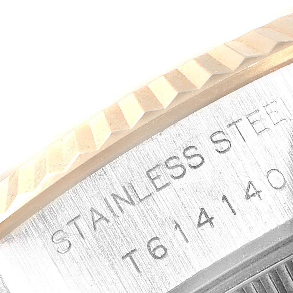 This image shows a close-up of the fluted bezel and part of the case back with "STAINLESS STEEL" engraving on a Rolex Datejust 69173 Women's Stainless Steel Champagne Dial 69173 Women's Stainless Steel Champagne Dial watch.