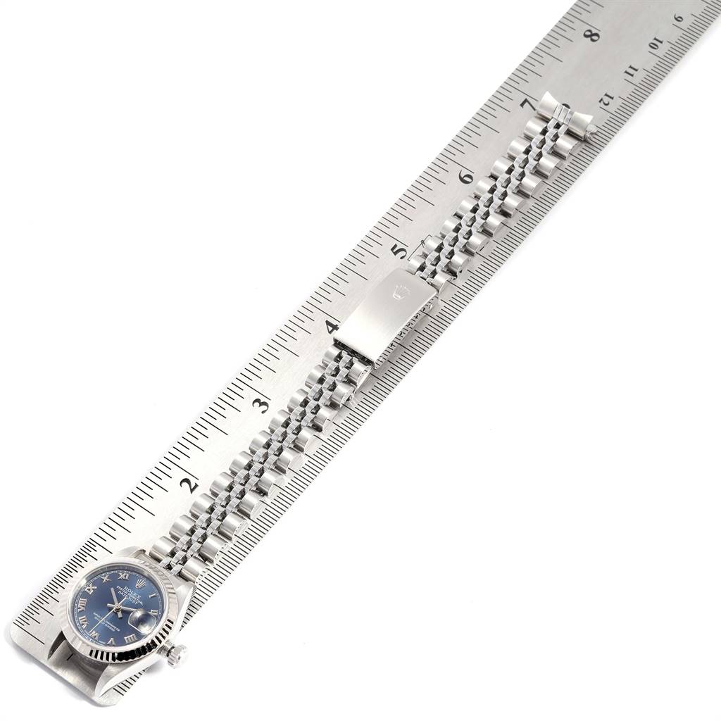 The image shows the Rolex Datejust 79174 Women's Stainless Steel Blue Dial 79174 Women's Stainless Steel Blue Dial watch and its bracelet lying flat along a ruler, displaying the full band and watch face clearly.