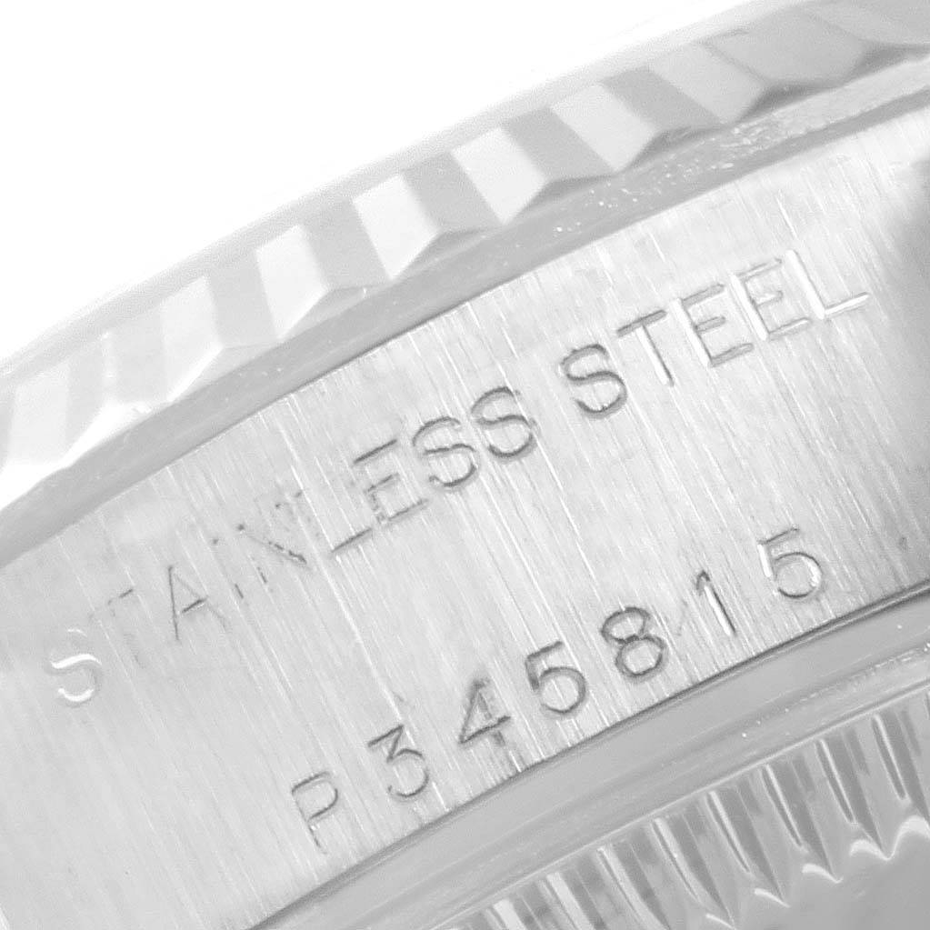 The image shows an engraved part of the stainless steel casing of a Rolex Datejust 79174 Women's Stainless Steel Blue Dial 79174 Women's Stainless Steel Blue Dial watch.