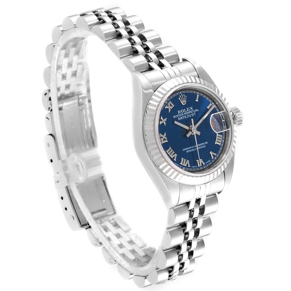 The image shows a Rolex Datejust 79174 Women's Stainless Steel Blue Dial 79174 Women's Stainless Steel Blue Dial watch from an angled side view, highlighting its Jubilee bracelet, fluted bezel, and blue dial.