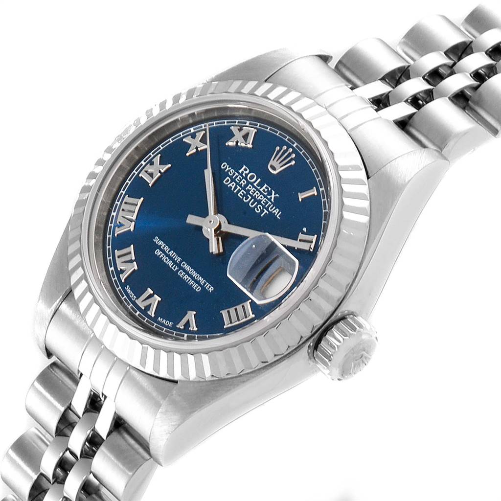 The image shows a Rolex Datejust 79174 Women's Stainless Steel Blue Dial 79174 Women's Stainless Steel Blue Dial watch at an angled view, highlighting its blue dial, fluted bezel, and stainless steel Jubilee bracelet.