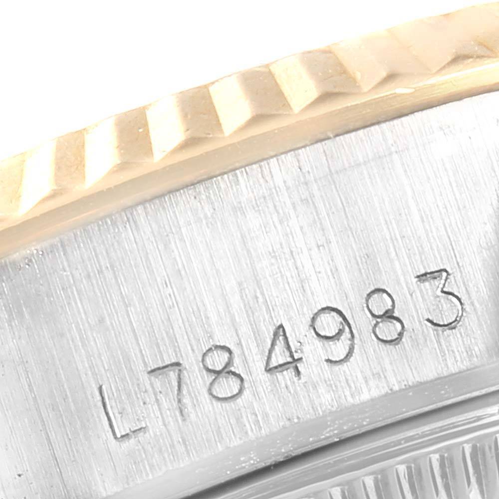 The image shows a close-up of the serial number and fluted bezel of a Rolex Datejust 69173 Women
s Stainless Steel Champagne Dial 69173 Women
s Stainless Steel Champagne Dial watch.