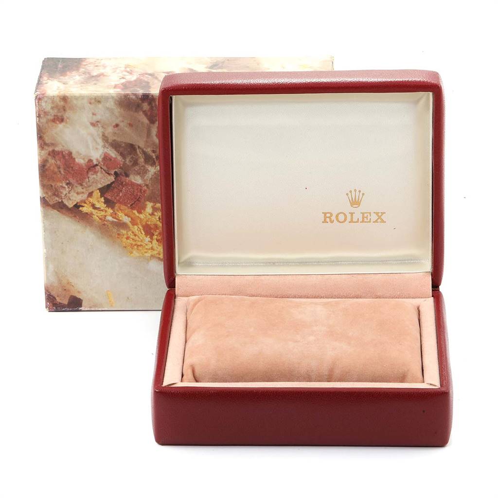 The image shows an open Rolex Datejust 69173 Women
s Stainless Steel Champagne Dial 69173 Women
s Stainless Steel Champagne Dial watch box, displaying the interior with the brand
s logo and a cushion for the watch.