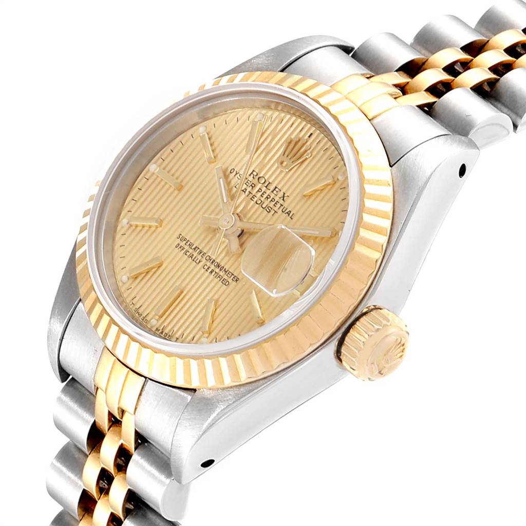 The Rolex Datejust 69173 Women
s Stainless Steel Champagne Dial 69173 Women
s Stainless Steel Champagne Dial watch is shown from an angled perspective, displaying its dial, crown, bezel, and part of the bracelet.