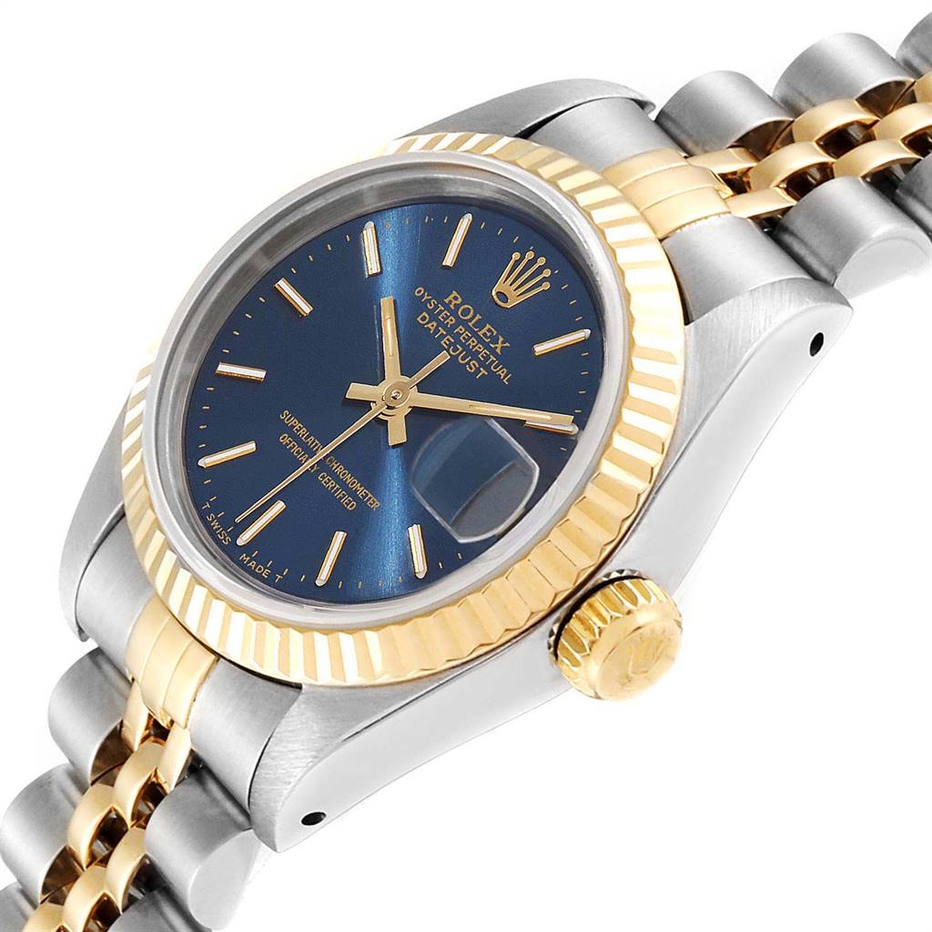 The image shows a Rolex Datejust 69173 Women
s Stainless Steel Blue Dial 69173 Women
s Stainless Steel Blue Dial watch at an angle, highlighting the blue dial, gold fluted bezel, and two-tone Jubilee bracelet.