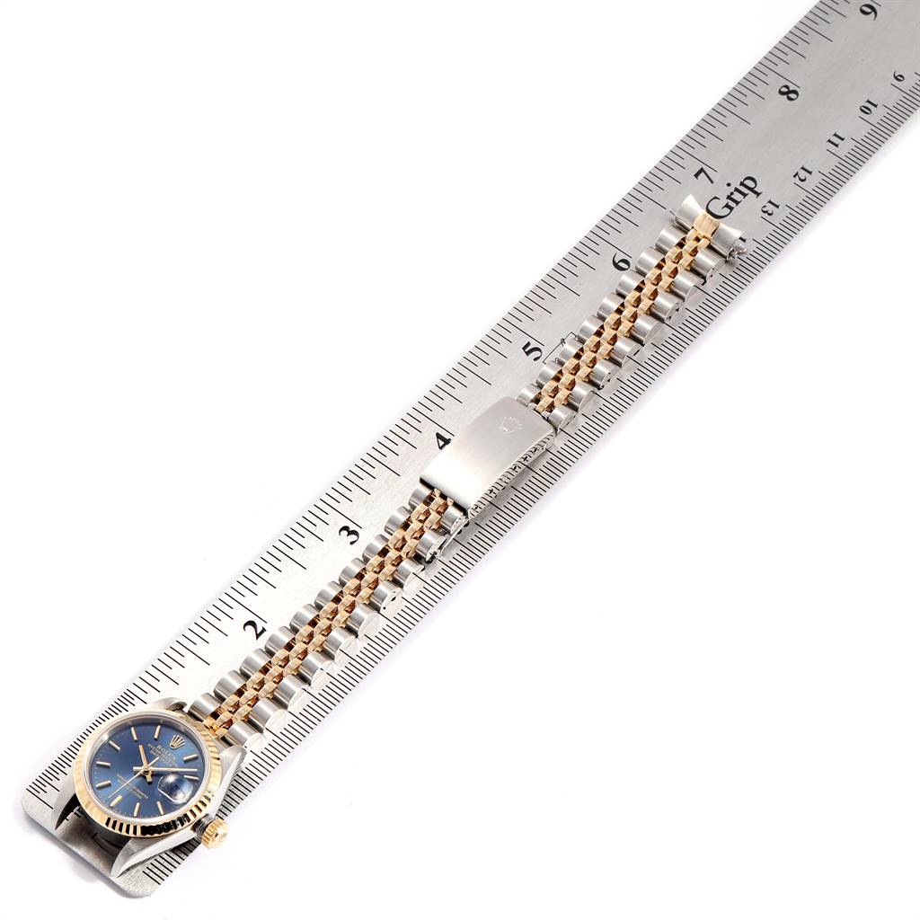 The image shows a Rolex Datejust 69173 Women
s Stainless Steel Blue Dial 69173 Women
s Stainless Steel Blue Dial watch laid flat on a ruler, highlighting its bracelet and clasp.