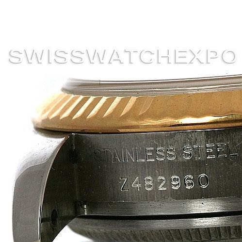 The image shows a close-up of the side of a Rolex Datejust 179173 Women's Steel and Gold (two tone) White Dial 179173 Women's Steel and Gold (two tone) White Dial watch, highlighting the stainless steel casing, bezel, and serial number.