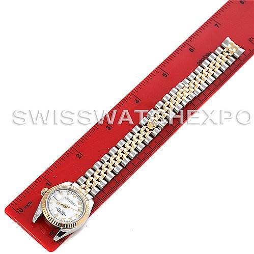 The image shows a Rolex Datejust 179173 Women's Steel and Gold (two tone) White Dial 179173 Women's Steel and Gold (two tone) White Dial watch with a two-tone Jubilee bracelet, placed next to a red ruler for measurement.