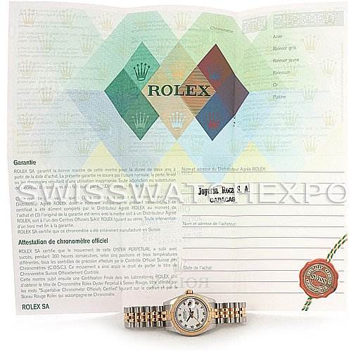 The image shows a Rolex Datejust 179173 Women's Steel and Gold (two tone) White Dial 179173 Women's Steel and Gold (two tone) White Dial watch placed in front of its warranty and chronometer certification papers.