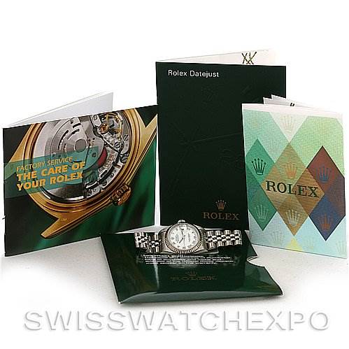 The image showcases Rolex Datejust 79174 Women's Stainless Steel White Dial 79174 Women's Stainless Steel White Dial watch accessories, including booklets and a green wallet with the watch displayed in front.