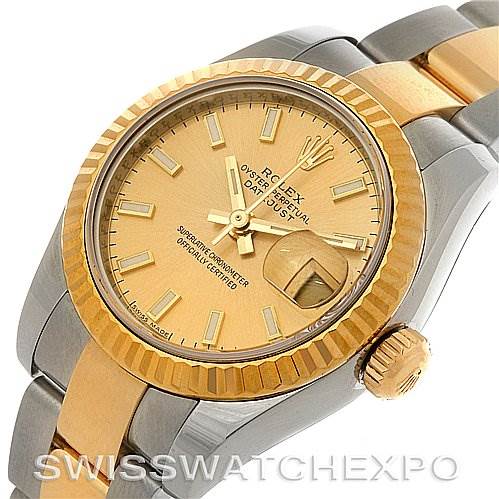 This image shows a Rolex Datejust 179173 Women's Steel and Gold (two tone) Champagne Dial 179173 Women's Steel and Gold (two tone) Champagne Dial watch with a close-up angle highlighting the dial, bezel, and part of the bracelet.