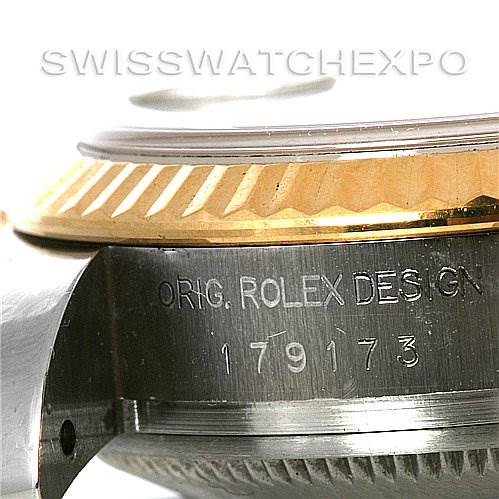 This close-up shows the side edge of the Rolex Datejust 179173 Women's Steel and Gold (two tone) Champagne Dial 179173 Women's Steel and Gold (two tone) Champagne Dial watch, focusing on the bezel and the engraved model number.