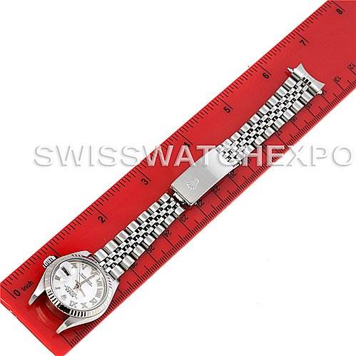 The image shows a Rolex Datejust 79174 Women's Stainless Steel Mother of Pearl Dial 79174 Women's Stainless Steel Mother of Pearl Dial watch from a top-down angle, highlighting the watch face, bezel, and bracelet clasp against a ruler.