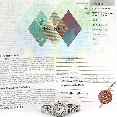 The image shows a Rolex Datejust 79174 Women's Stainless Steel Mother of Pearl Dial 79174 Women's Stainless Steel Mother of Pearl Dial watch from a top-down angle, along with warranty and certification documents.