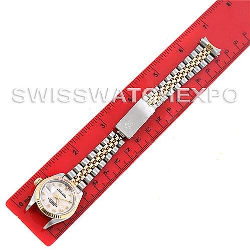 The image shows a top-down view of a Rolex Datejust 69173 Women's Stainless Steel Beige Dial 69173 Women's Stainless Steel Beige Dial watch with a Jubilee bracelet placed on a red ruler.