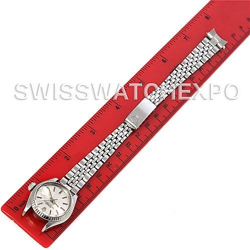The image shows a top-down view of the Rolex Datejust 6917 Women
s Stainless Steel Silver Dial 6917 Women
s Stainless Steel Silver Dial watch, alongside a red ruler for scale.