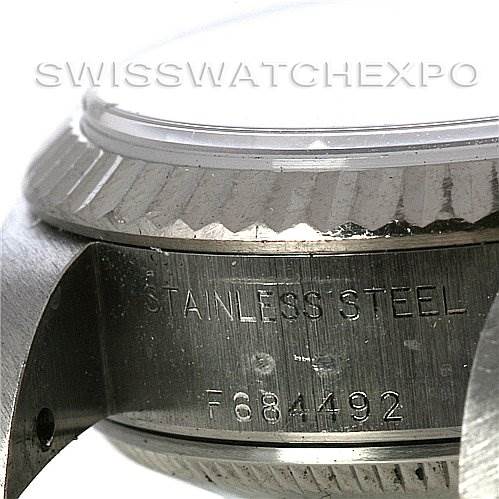 This is a close-up of the side of a Rolex Datejust 79174 Women's Stainless Steel Brown Dial 79174 Women's Stainless Steel Brown Dial watch, showing the stainless steel case and serial number.