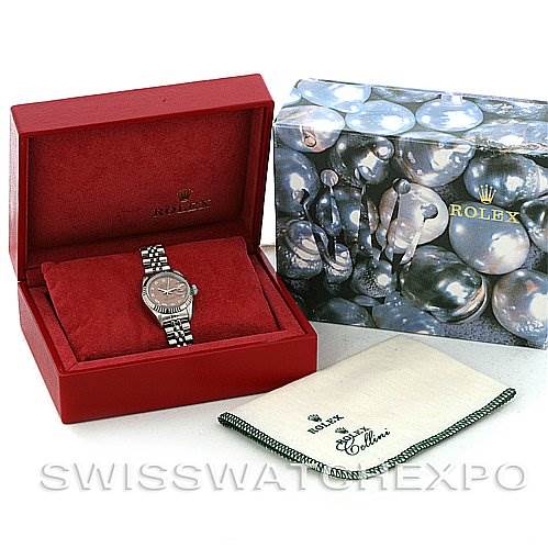 The image shows a Rolex Datejust 69174 Women's Stainless Steel Pink Dial 69174 Women's Stainless Steel Pink Dial watch in a red Rolex box, with a branded outer box and cleaning cloth beside it.