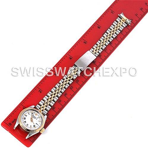 The Rolex Datejust 69173 Women's Stainless Steel White Dial 69173 Women's Stainless Steel White Dial watch is shown in a top-down view, including the face, case, and full two-tone bracelet next to a red ruler.