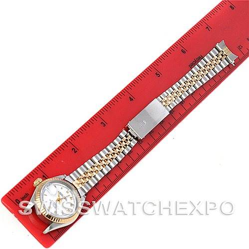 This image shows a Rolex Datejust 69173 Women's Stainless Steel White Dial 69173 Women's Stainless Steel White Dial watch laid flat along a red ruler, displaying the face and entire bracelet.