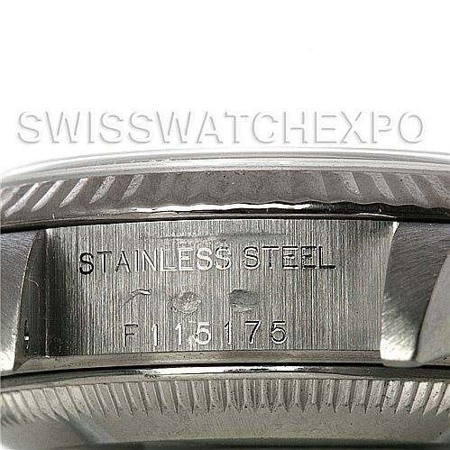 The image shows a close-up of the side of a Rolex Datejust 79174 Women's Stainless Steel White Dial 79174 Women's Stainless Steel White Dial watch case, highlighting the "STAINLESS STEEL" engraving and serial number.