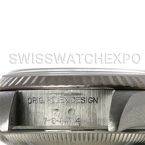 The image shows the side view of a Rolex Datejust 79174 Women's Stainless Steel White Dial 79174 Women's Stainless Steel White Dial watch, focusing on the engraved model number and "ORIG. ROLEX DESIGN."