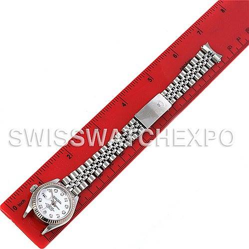 The Rolex Datejust 79174 Women's Stainless Steel White Dial 79174 Women's Stainless Steel White Dial watch is shown from a top-down angle, placed next to a red ruler, displaying its bracelet and face.